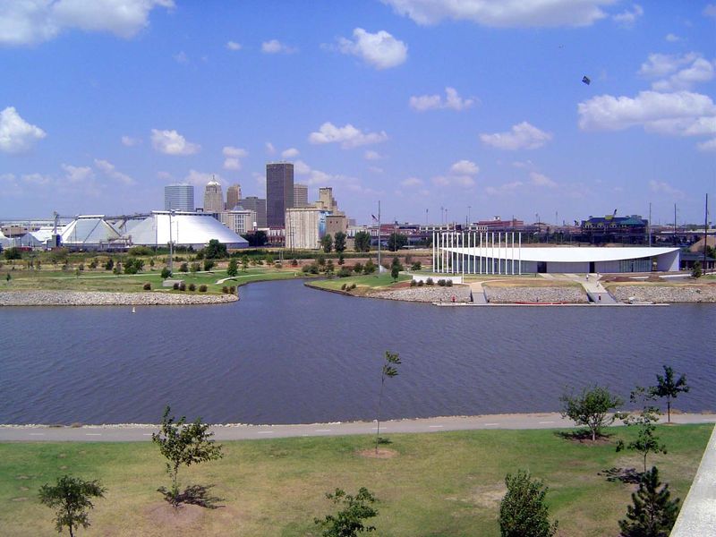 We're looking at the ponded river. The tributary is the arriving end of the man-made Bricktown canal. The building to its right is a boat ho