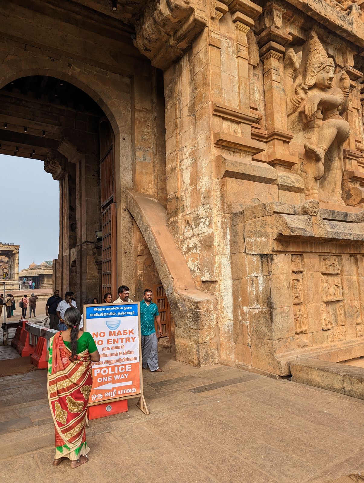The fanged dvavapalas are supposed to guard the temple, but they don't even scare people into wearing the required masks.