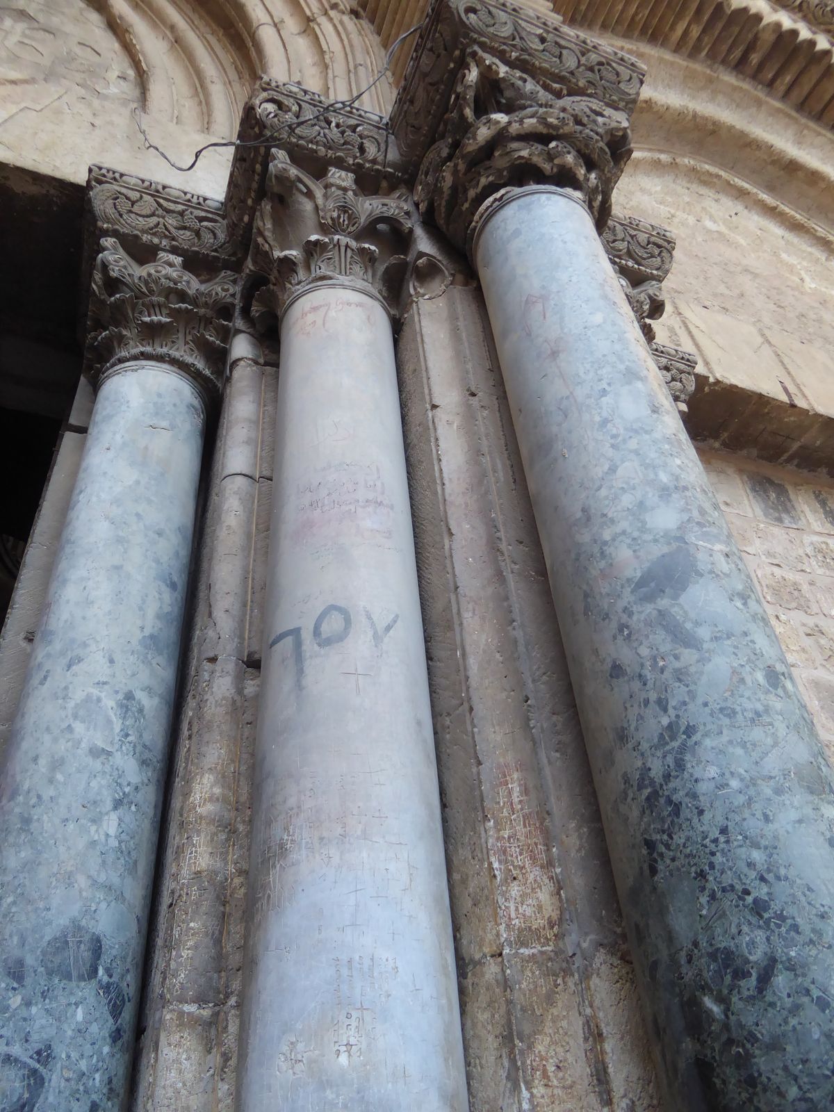 Never mind the crowds in the courtyard outside the Church of the Holy Sepulcher. Just touch the columns flanking the door.