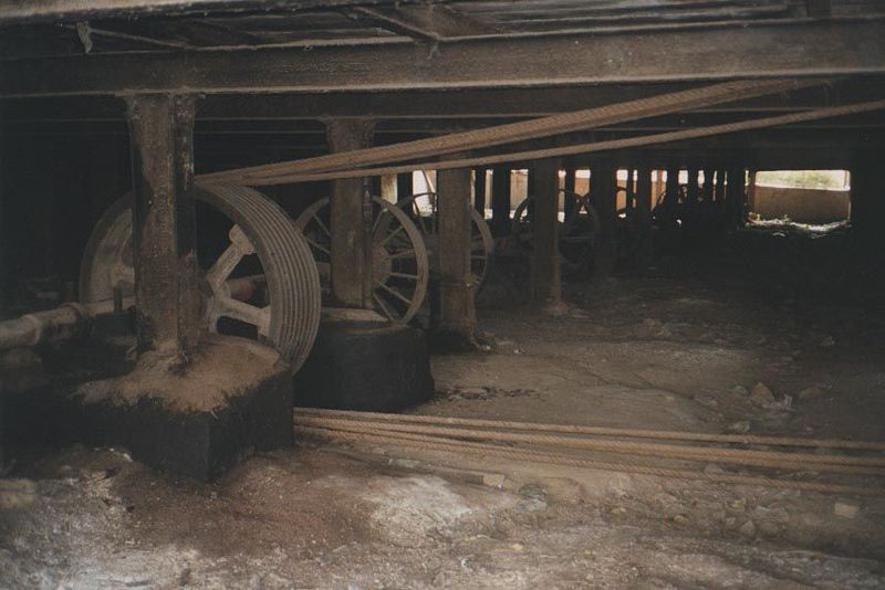Down below, elaborate belting connected the steam engine to the mill's circular saws.