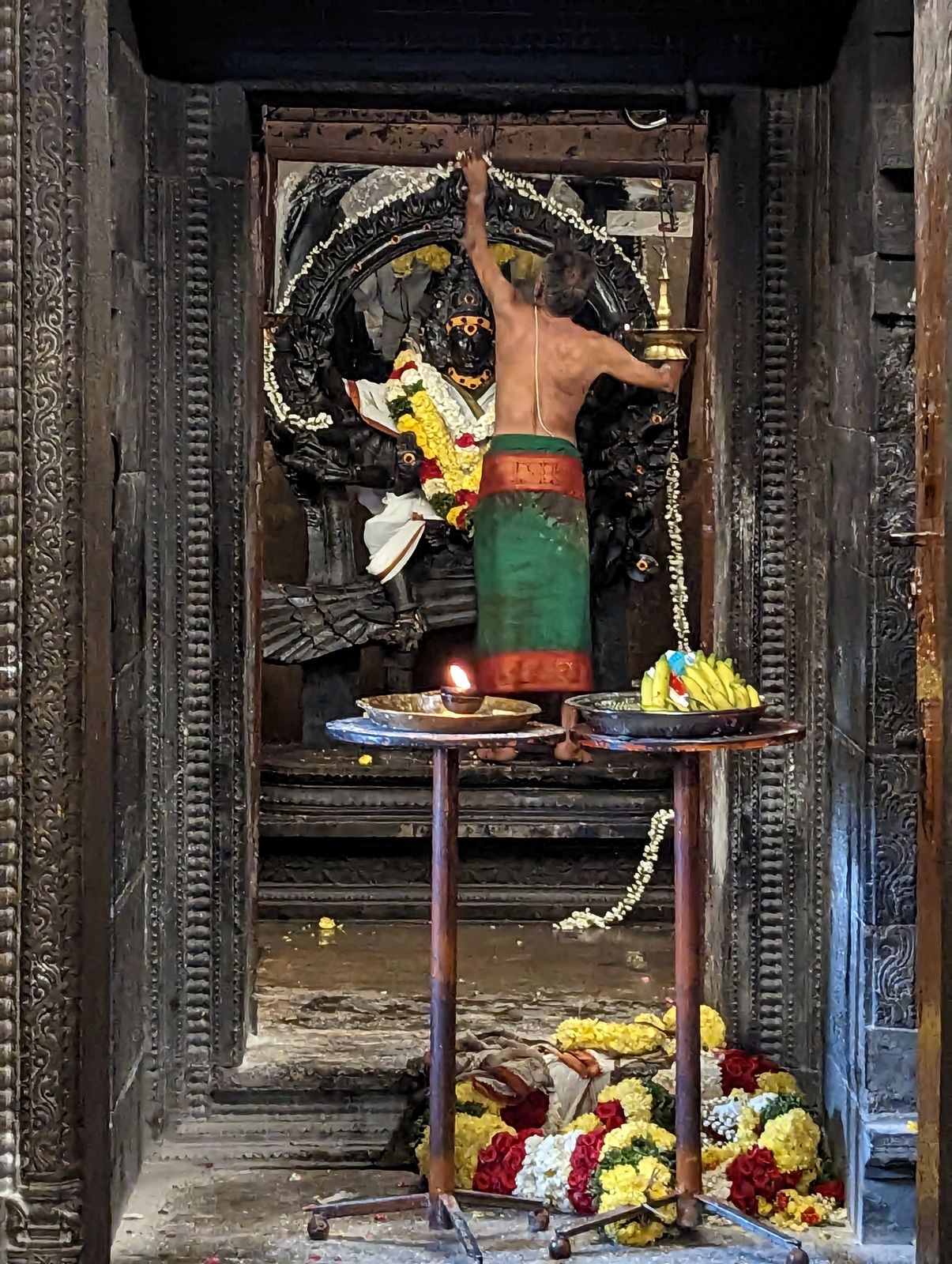 A priest cares for the image of Subrahmanya, a son of Shiva.