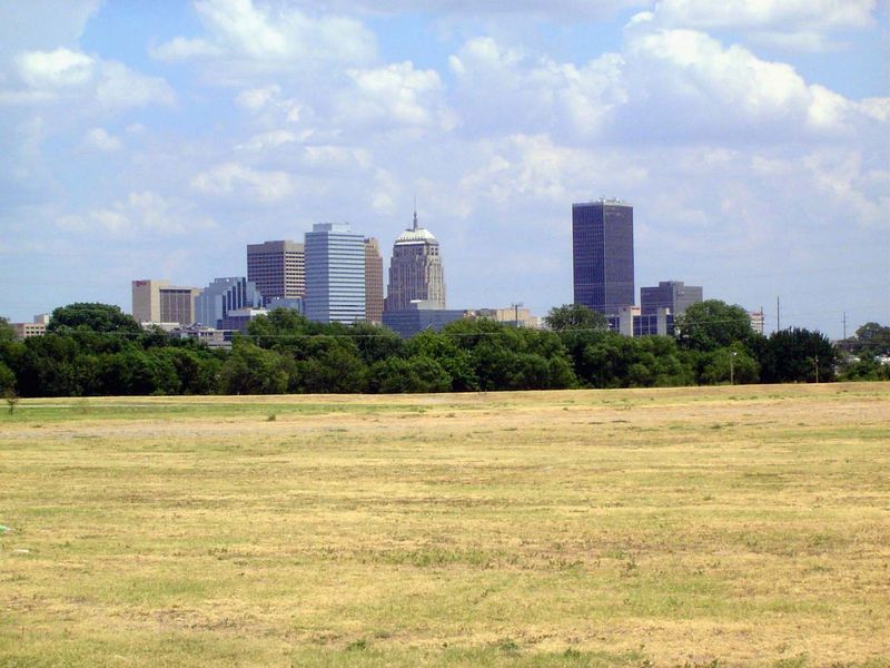 The same group of towers seen more handsomely from the southwest, just south of the tree-fringed river. To the left of the gray Kerr-McGee \