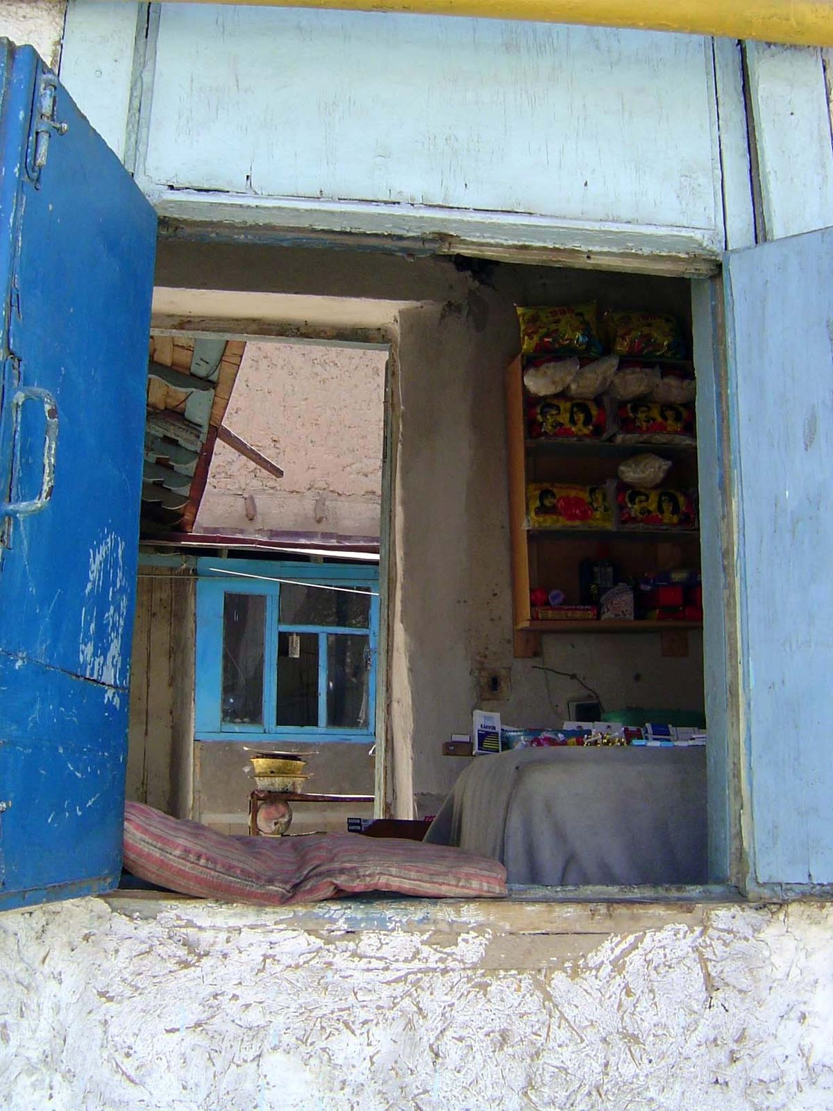 Another, with shutters onto the street and a cushion for the merchant.