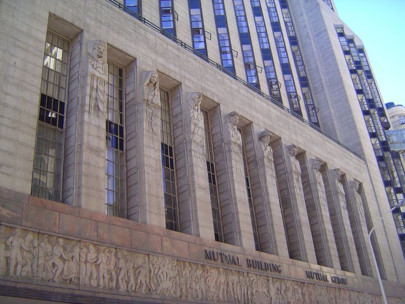Bas-reliefs wrap the building much like the Voortrekker Monument outside Pretoria. The carving is by Ivan Mitford-Barberton. The larger figu