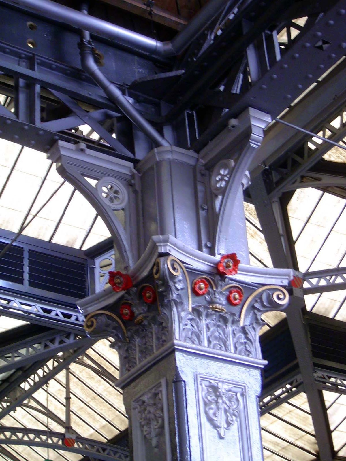 An interior detail, with cast-iron skeleton and glass roof.