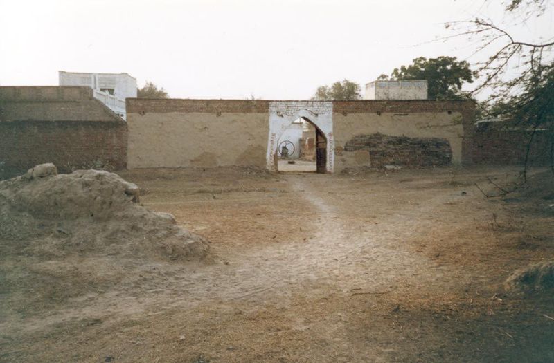 One family was still resident behind this gate. That circular object visible through the gate is probably a manually operated fodder chopper