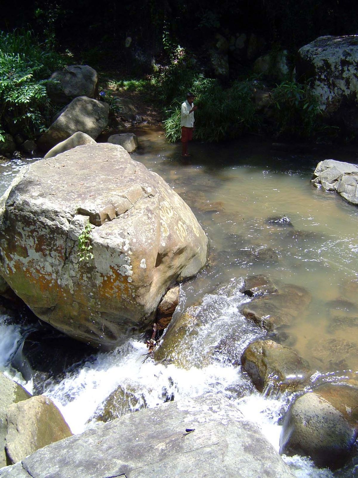 It ends at this stream, although traffic continues with deft footwork on stones lying a few inches below the water.