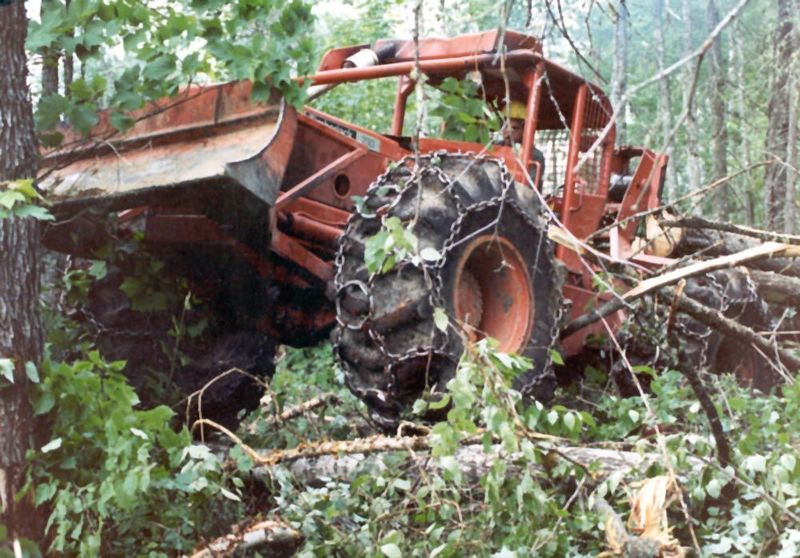 Skidding the logs out to a landing. The chopper's partner handles this part of the work and brooks few obstacles.