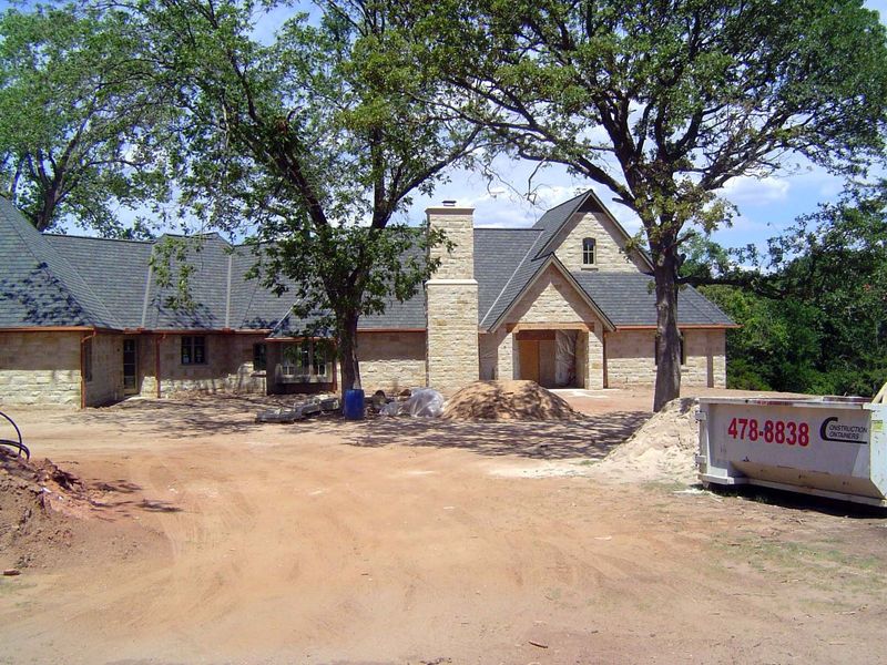 Next door, a new home takes shape at the high end.