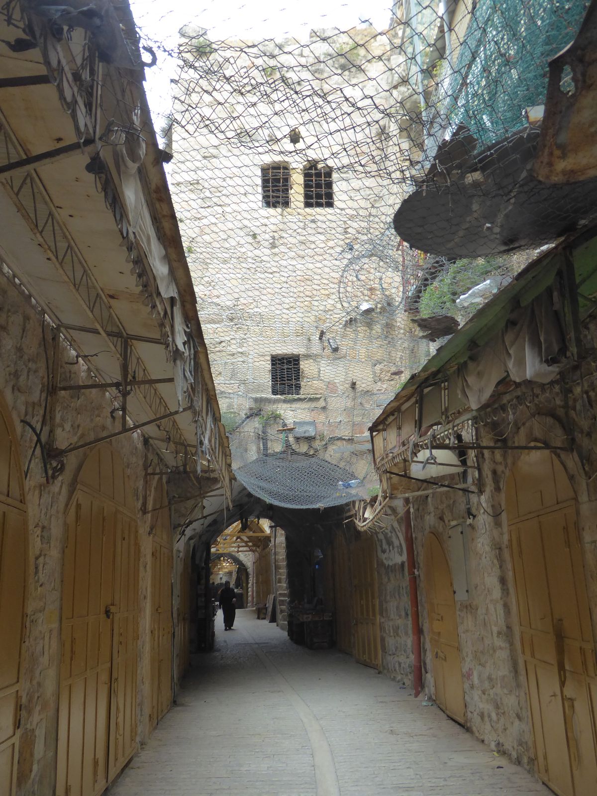 One section is said to have been fenced to protect passersby from rocks tossed by Jewish settlers in the building above.