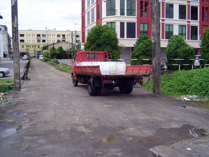 We've come here to juxtapose old and new. Right next to the building in the last picture, a truck approaches with big blocks of ice.