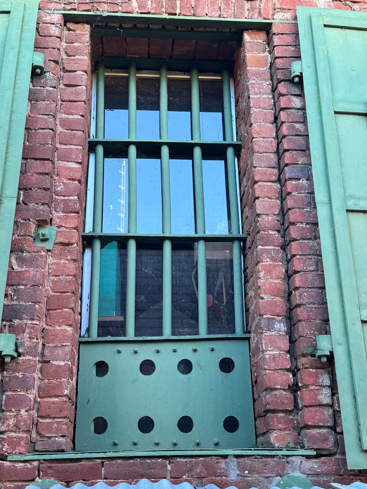 Not quite sure why you want shutters in addition to bars.  Maybe to protect prisoners from high or low temperatures?  Or maybe they're just 