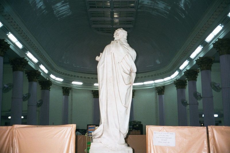 Proconsul in toga, bathed in fluorescent light. This happens to be Mountstuart Elphinstone, by Chantrey, in the reading room of the old Town