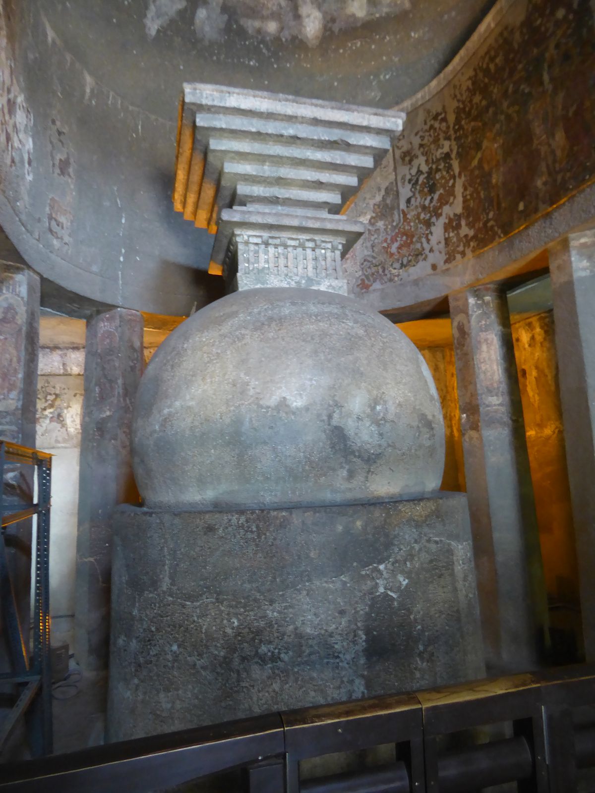 The focal point is a stupa of five parts. The base is the medhi. Above it is the spherical anda or egg. Above that is the relic box called t