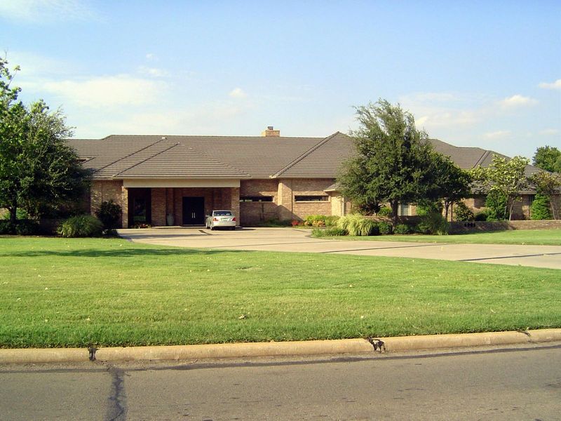 Across the street at 6901 Grand, this house from 1996 hides from the street.