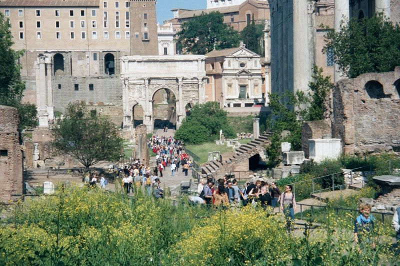 Looking west from the Arch of Titus over the Roman forum. The view extends past the triple Arch of Septimius Severus, built in 203 to celebr