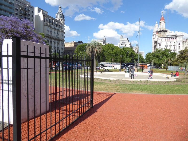 We've edged farther west still to the Plaza Lorea, a rare bit of green space in the city. The fenced monument?