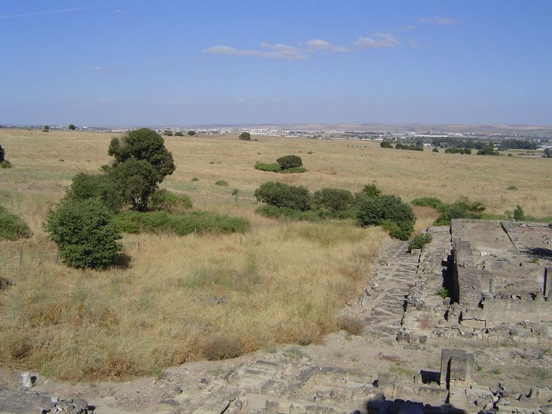 The plains of the Guadalquivir, with Cordoba in the distance and the ruins of the mosque of Medina Azahara in the right foreground. The inte