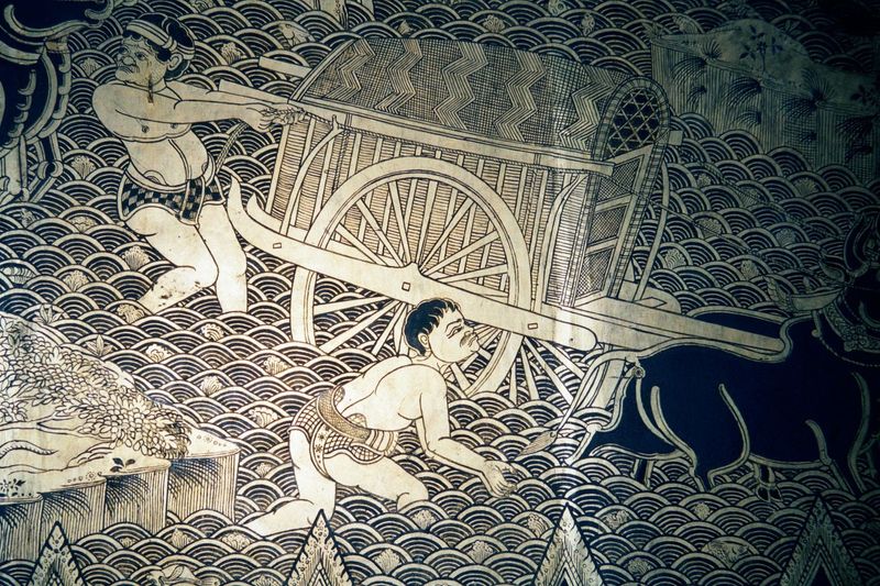 Carts cross a river. They illustrate a well-known miracle: the Buddha in old age asked his disciple Ananda to fetch water from a stream that