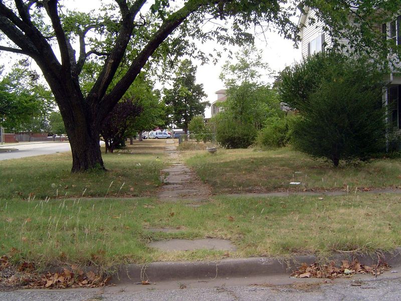 The commercial buildings have been replaced, but some older features remain, like this sidewalk.
