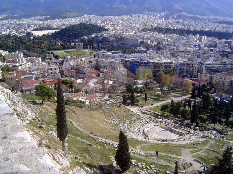 Looking down from the Acropolis to the remains of the Theater of Dionysus, where plays by Sophocles premiered. In the distance just before t