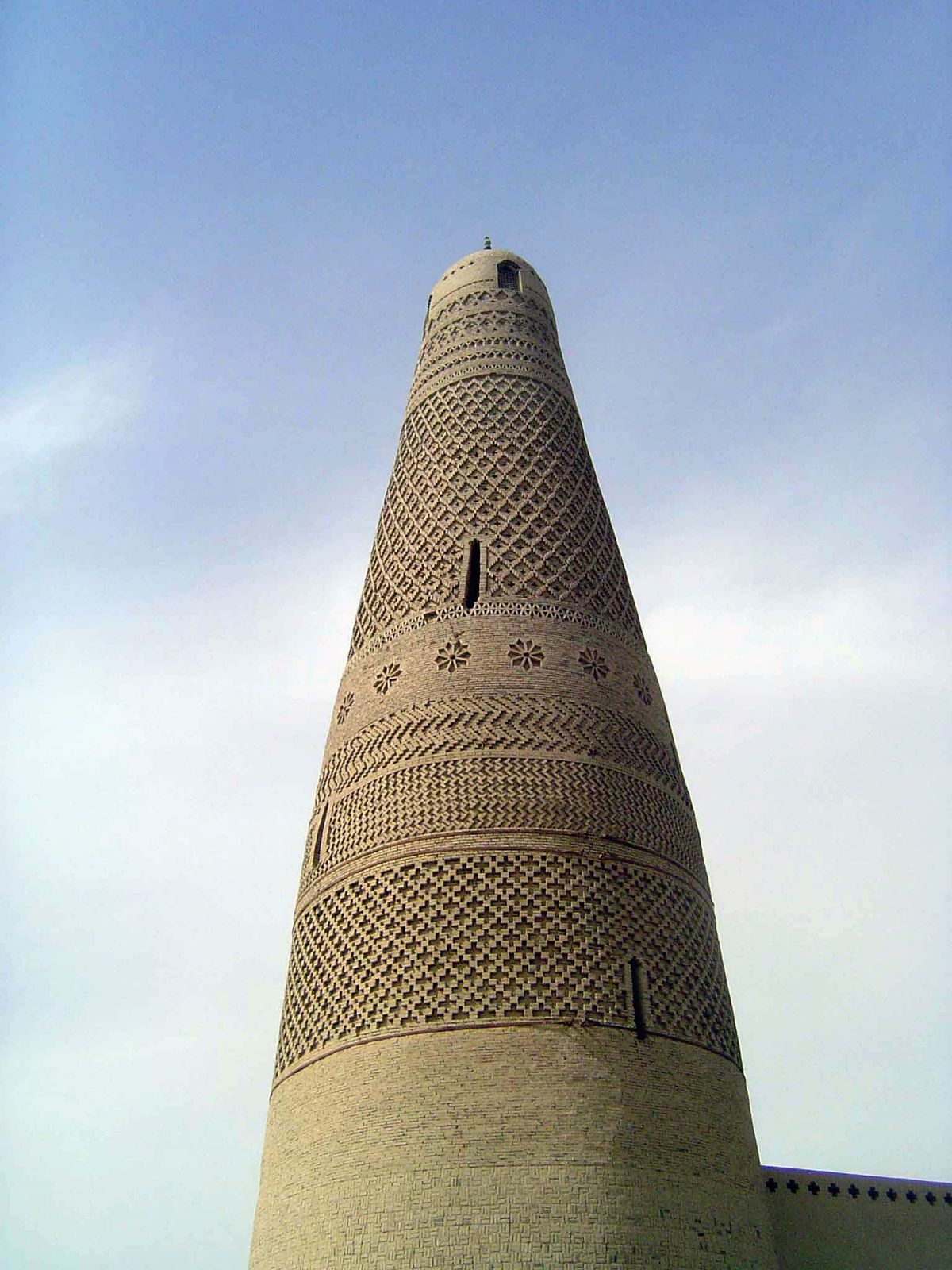 The minaret is strikingly similar to those far to the west. See, for example, the pictures from Khiva, Uzbekistan.