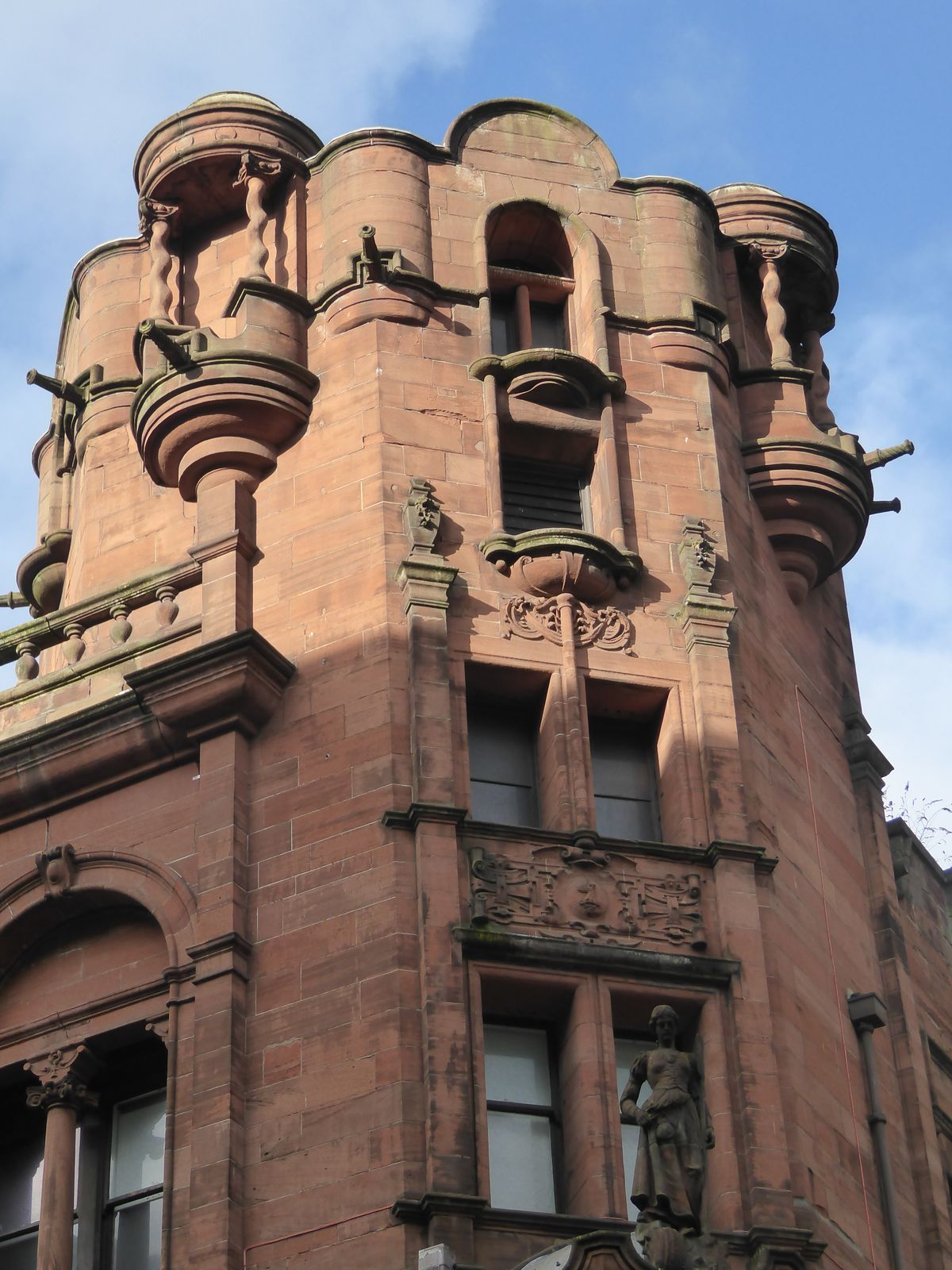 The baldacchini never got the intended statues of the four seasons, but the corner of the building got what Williamson calls a highland lass