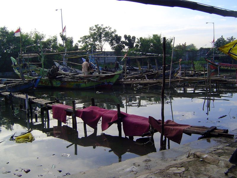 We're on the coast and so there's a fishing village. Behind the barbed wire and lit by those tall poles, however, there's a port unloading o