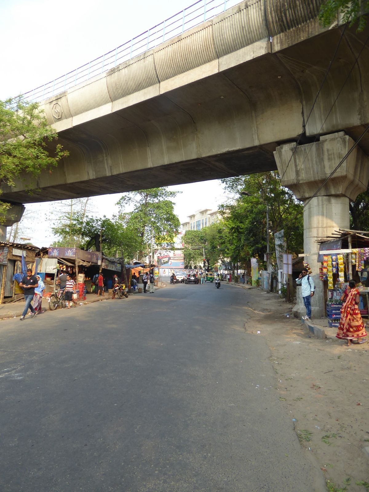 Next morning we escape, head down Narkeldanga Road, and duck under a Calcutta Metro line still under construction.