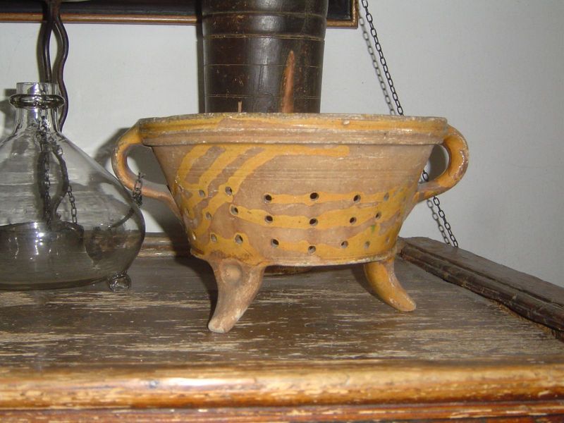 A pottery colander.