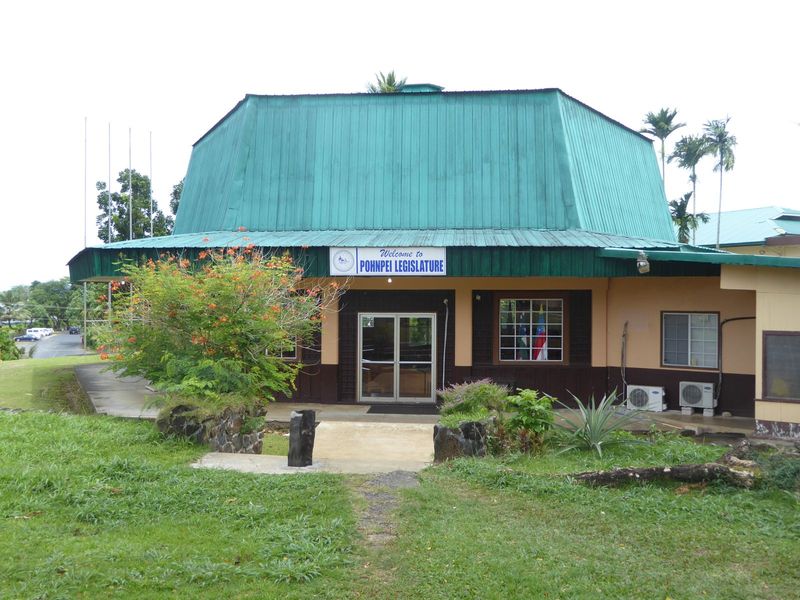 The Pohnpei Legislature meets here. Who do you think built the place? For the answer, walk over to the group of flagpoles.