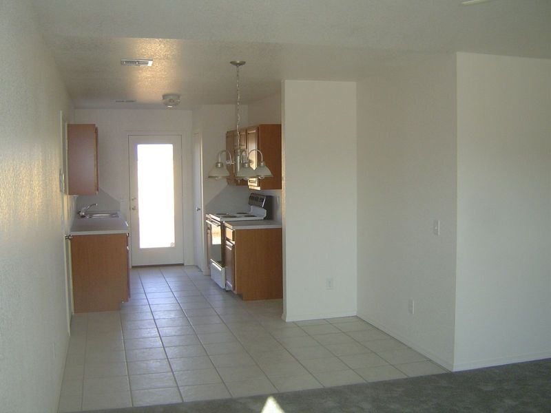 We're standing in the living room and looking toward the kitchen and dining. The door on the left is to the one-car garage. To the right are