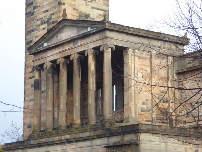 The temple front echoes the Ionic Erechtheion much more than it does the Doric Parthenon.