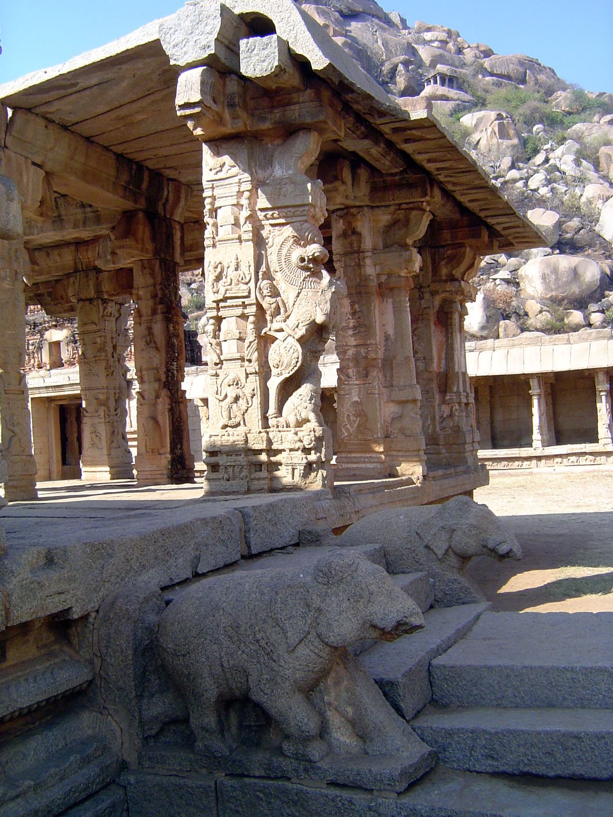 A half-lion, half-horse yali. He is mounted and leaps over a tiny kneeling elephant.