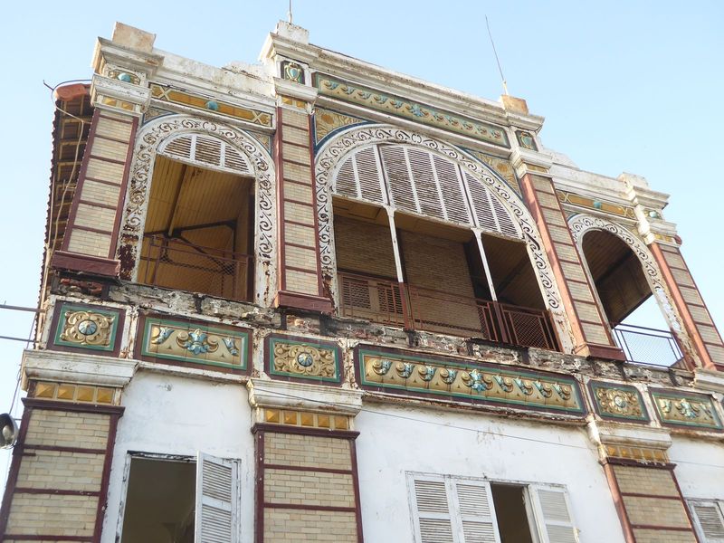 Iron frame, brick fill, faience trim. Still no ideas?