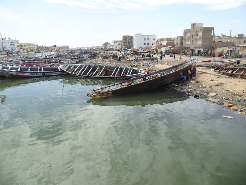 View looking downstream from the lower bridge, a simple concrete post-and-beam structure.