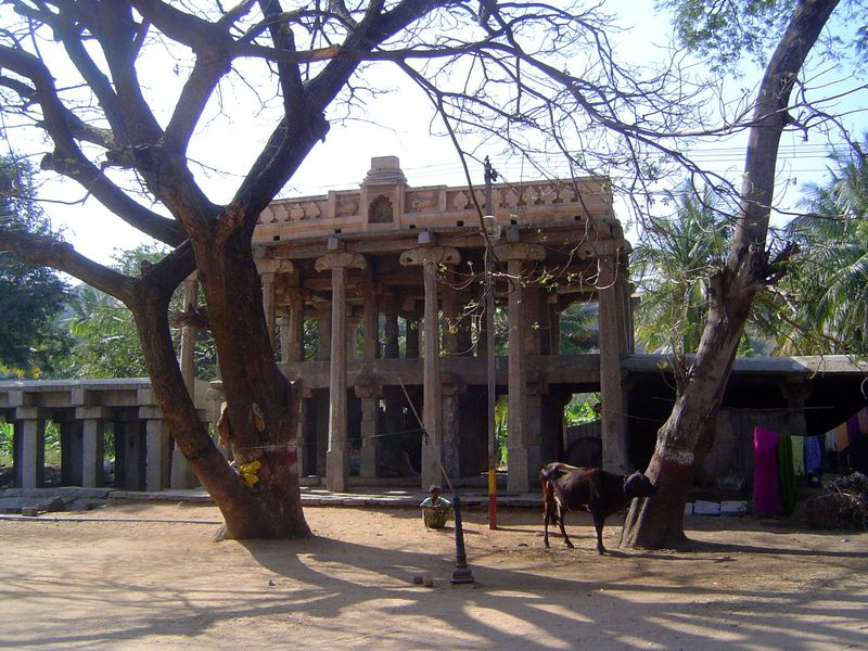 The bazaar is fringed by granite-framed buildings, in this case one with two storeys behind a high portico.