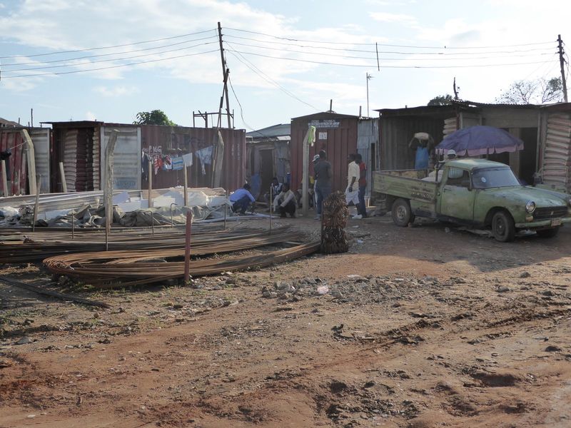 No Home Depot here, but lots of building materials. Rebar, of course; look closely and you'll see bags of cement.