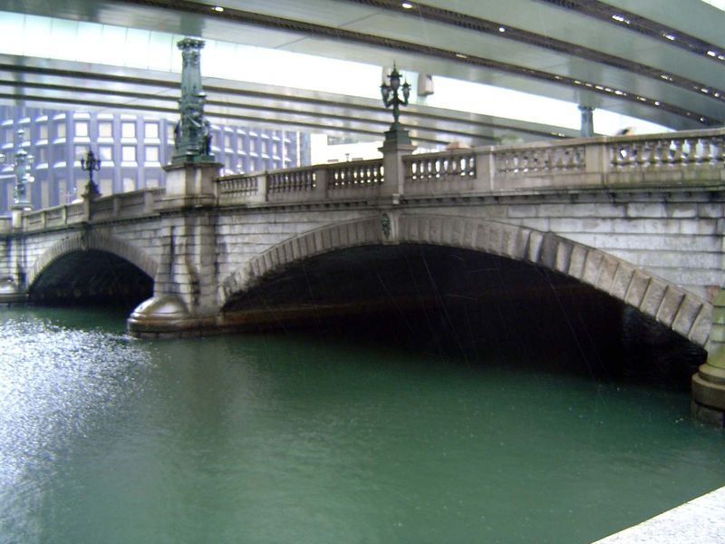 Nihombashi was rebuilt in 1911. Old photos show the new bridge sparkling white against a dark background, including a crude railway trestle 