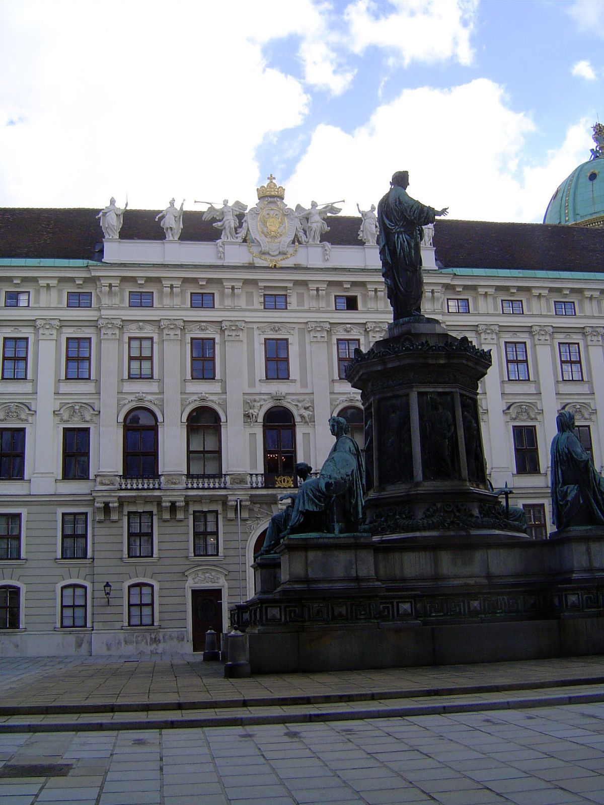 High on the old imperial chancellery are the arms of Charles VI, Maria Theresa's father. The statue of Francis I is by Pompeo Marchesi.