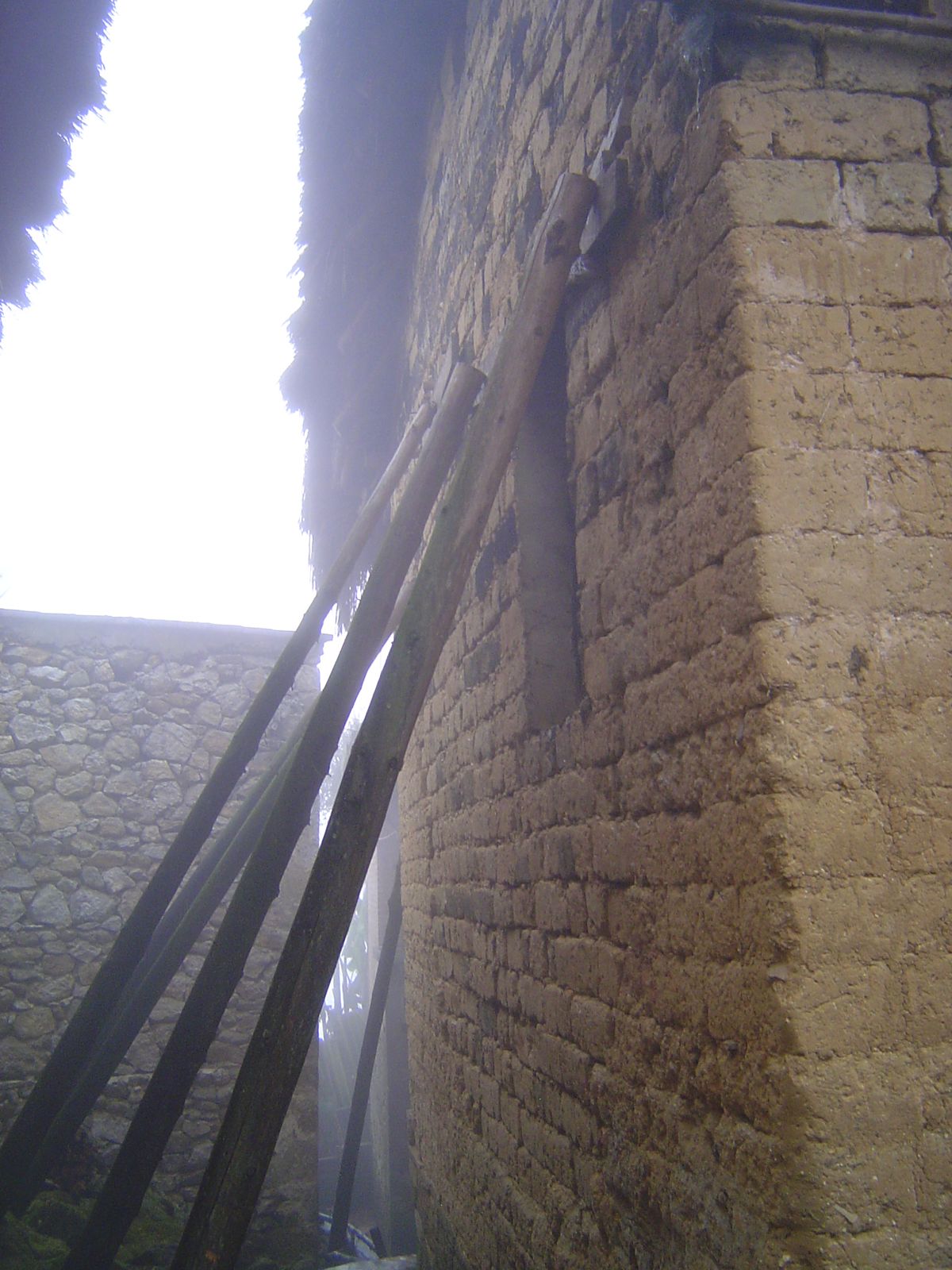 Bracing a mud wall that threatens to collapse.