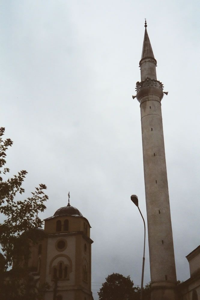 Juxtaposition of church and mosque—the first deserted, the second serving a population that wears Islam lightly.