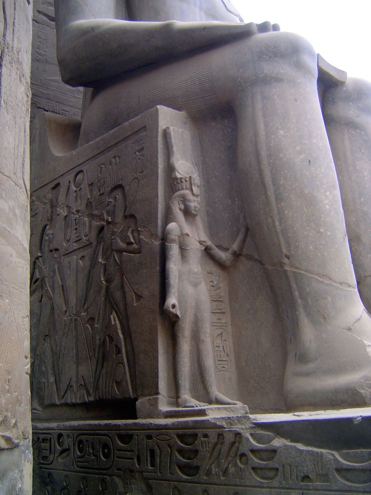 Lateral images of the king's wife and daughter don't even reach his knee; once again, the Nile gods are at the side.