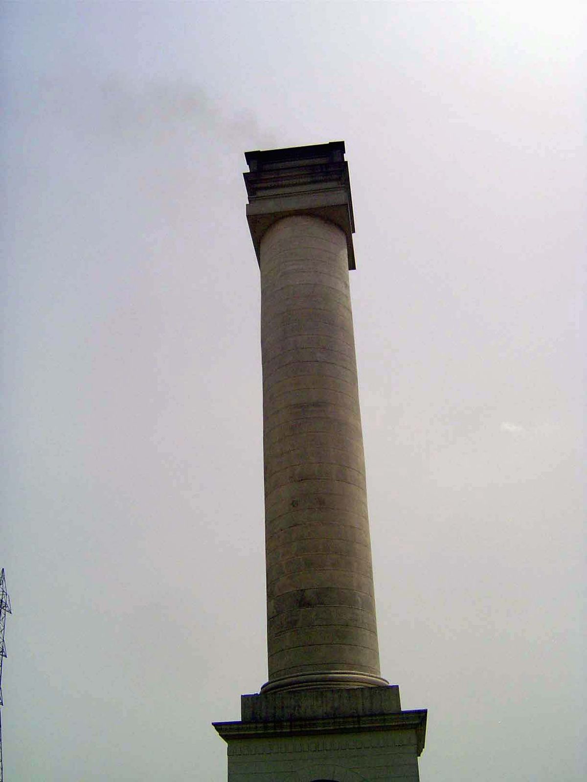 An ancient column of an unknown order? No; as the wisp at the top suggests, it's the stack for a shopping center.