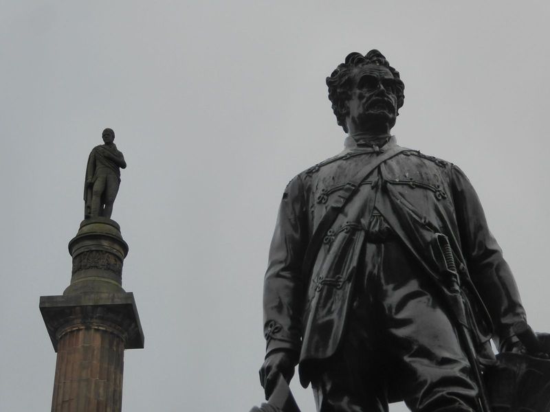 How's this for an unlikely pair? Atop the column, and wondering how to get down, is Walter Scott. He's been there since 1837, five years aft