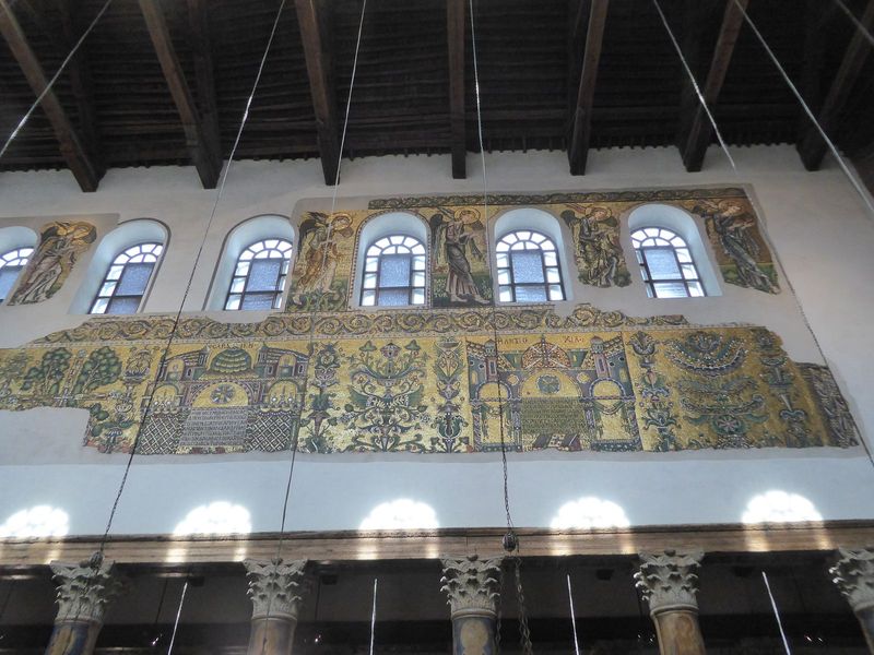 The mosaics date from a restoration in the 12th. Those are angels up top, and the figure third from the right has some letters behind his fe