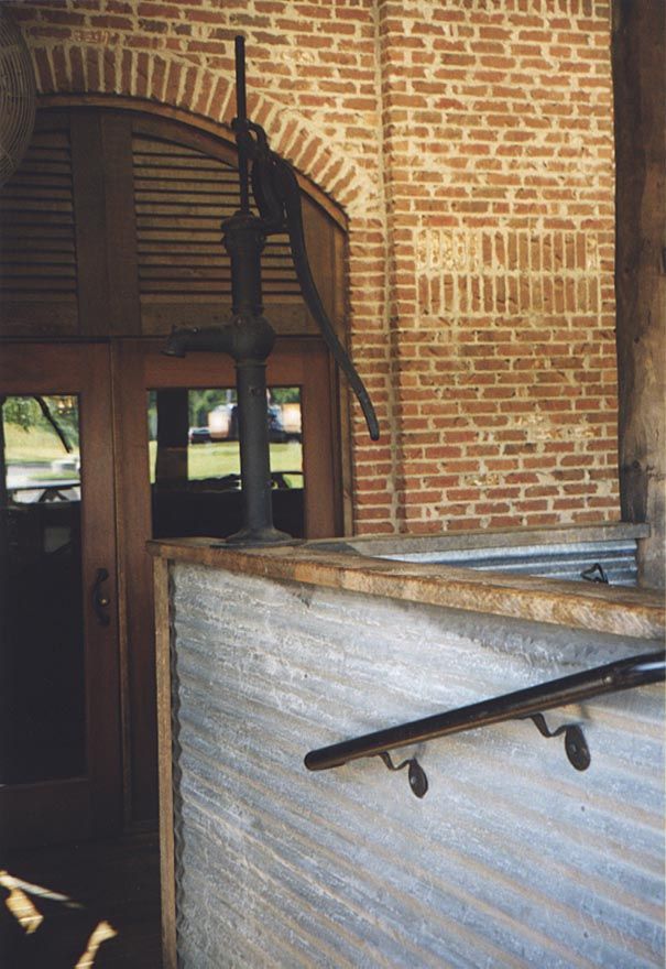 A pump theatens to douse disruptive customers. The handrail is a concession to the litigious.