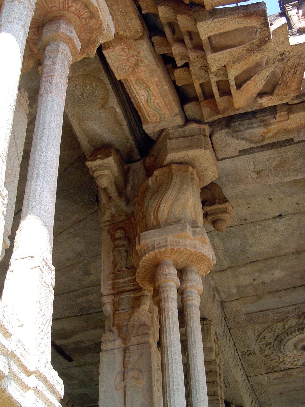 Cut-out colonettes support a flame-like capital. The roof has evidently shifted.