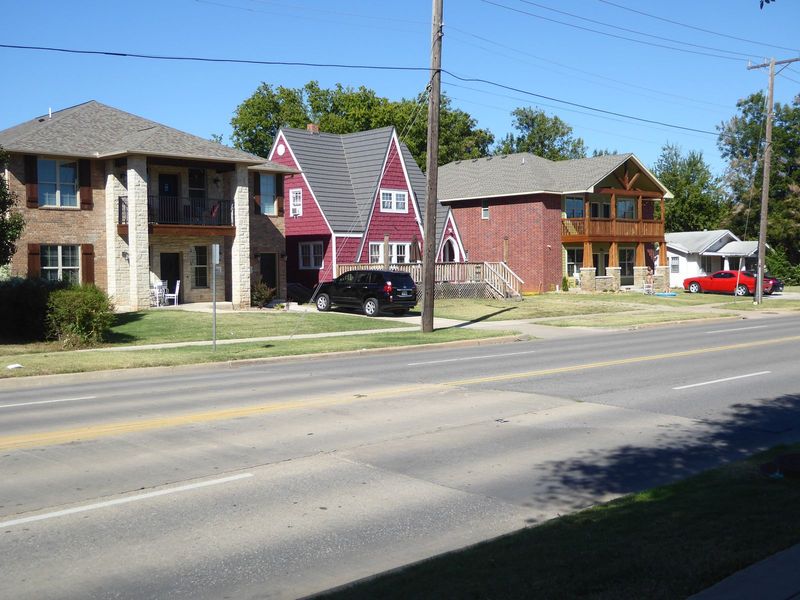 Here two duplexes squeeze into the spaces between older homes. See the odd red one?