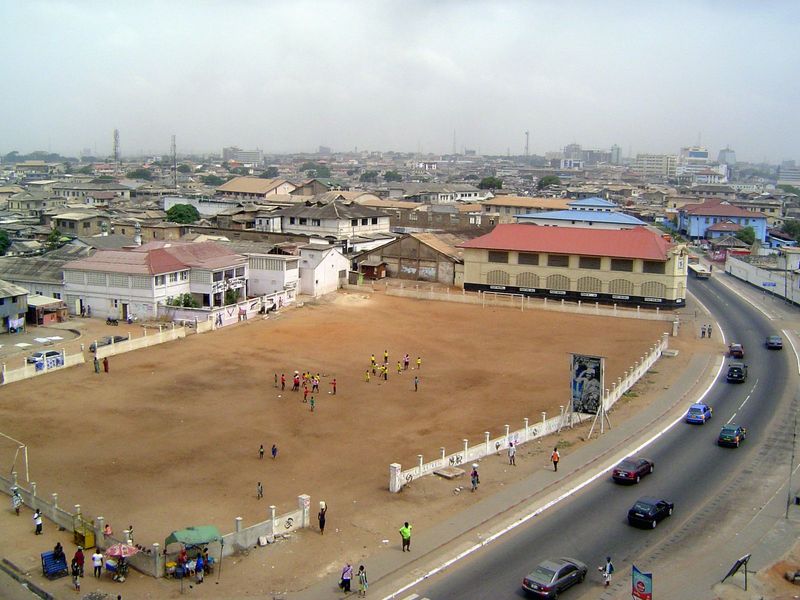 The multi-storied buildings of Accra Central are in the distance.